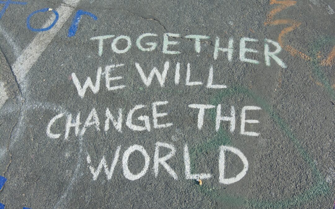 chalk writing on the ground saying together we will change the world